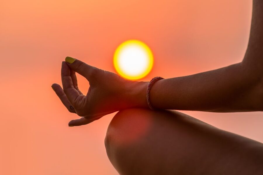 Meditating with sun behind