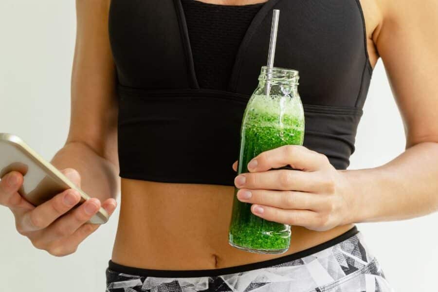 Fit woman using an app to track food and drinks