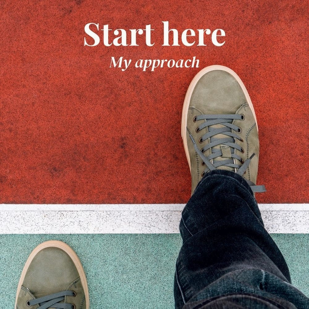 Two feet in lace up shoes with the right foot stepping forward over a white line on a red surface